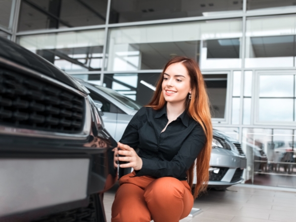Woman Inspecting a Car