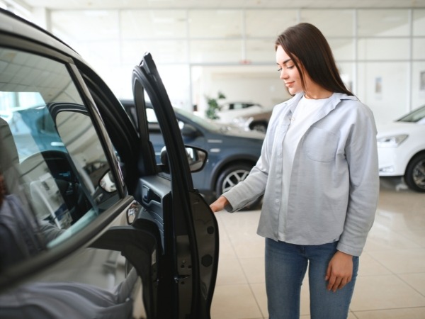 Woman Inspecting a Car