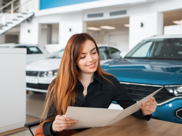 Woman Looking at Car Documents
