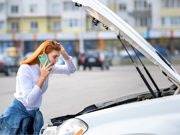 Woman Handling a Broken Down Car